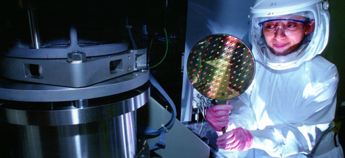 A scientist holding a radiation hardened computer chip A scientist holding a radiation hardened computer chip