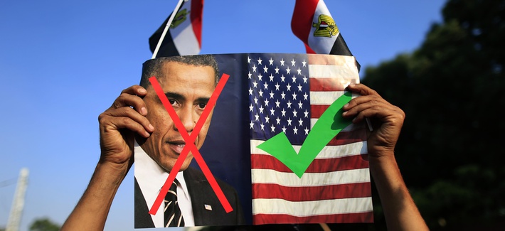 A protestor holds up a photo of President Obama and a U.S. flag in Cairo, Egypt A protestor holds up a photo of President Obama and a U.S. flag in Cairo, Egypt