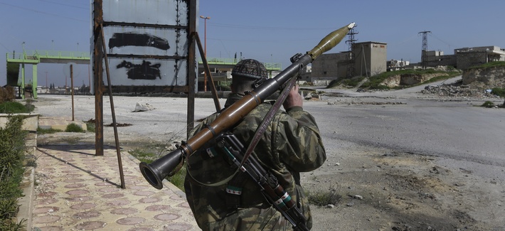 A Syrian rebel holds a rocket propelled grenade at a key highway A Syrian rebel holds a rocket propelled grenade at a key highway