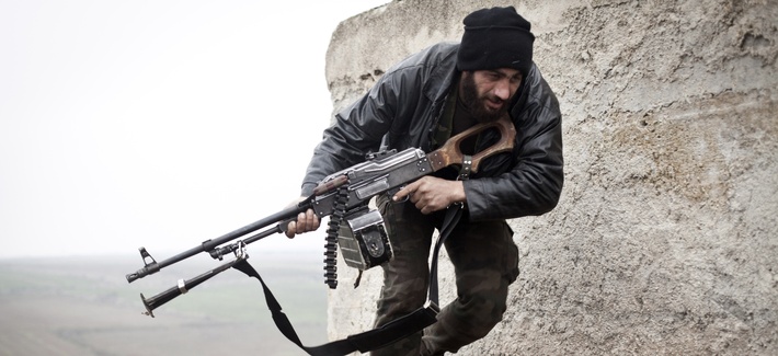 A Syrian opposition fighter running from opposing fire A Syrian opposition fighter running from opposing fire
