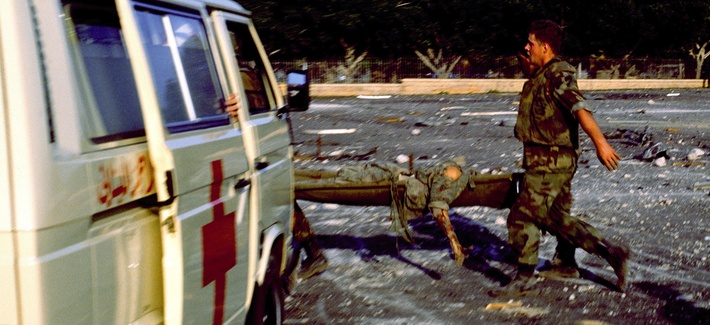 A Marine carries a wounded servicemember on October 23, 1983 in Beirut, Lebanon A Marine carries a wounded servicemember on October 23, 1983 in Beirut, Lebanon