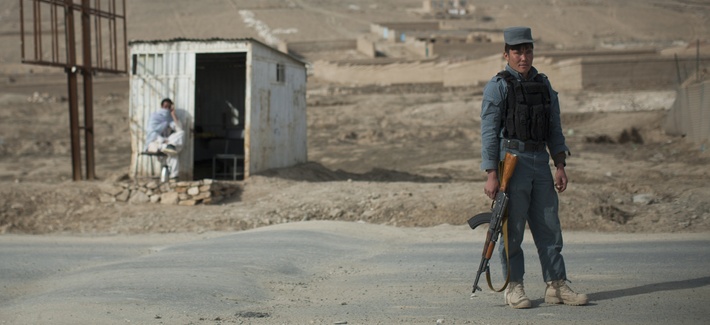 An Afghan policeman mans a checkpoint in Wardak province. An Afghan policeman mans a checkpoint in Wardak province.