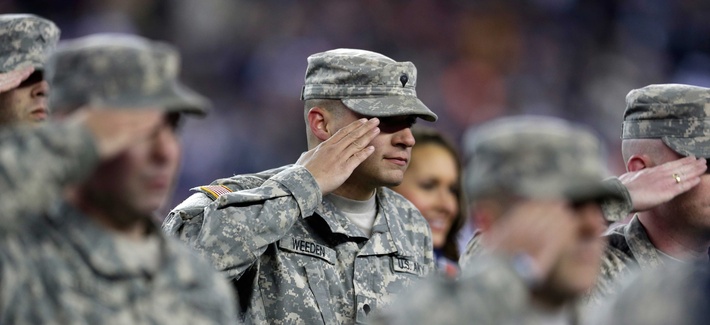 A soldier salutes active duty troops and veterans at a ceremony conducted during a football game between the Denver Broncos and the New England Patriots A soldier salutes active duty troops and veterans at a ceremony conducted during a football game between the Denver Broncos and the New England Patriots