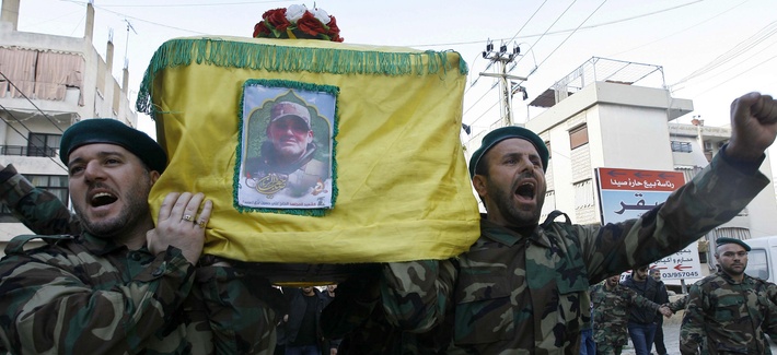 Hezbollah fighters in Lebanon carry the coffin of their commander Ali Bazzi, killed in Syria executing his "jihadi duties," in this photo from Dec. 9, 2013. Hezbollah fighters in Lebanon carry the coffin of their commander Ali Bazzi, killed in Syria executing his "jihadi duties," in this photo from Dec. 9, 2013.