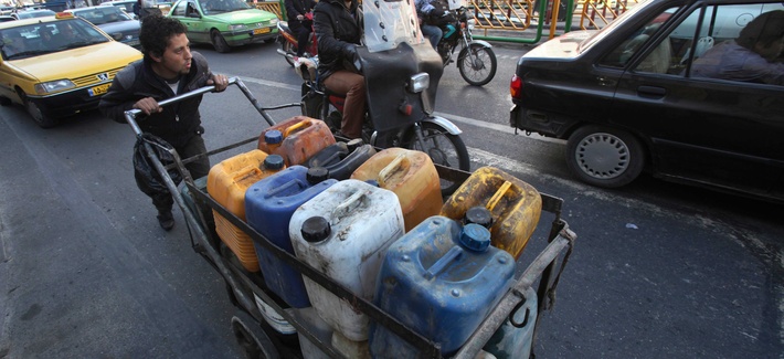 A boy pushes a cart loaded with fuel containers in Tehran, Iran A boy pushes a cart loaded with fuel containers in Tehran, Iran