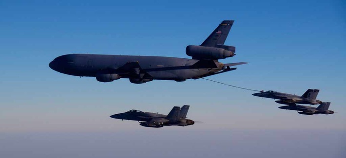 A KC-10A tanker refuels one of the Navy's F/A 18 fighter jets A KC-10A tanker refuels one of the Navy's F/A 18 fighter jets