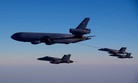 A KC-10A tanker refuels one of the Navy's F/A 18 fighter jets