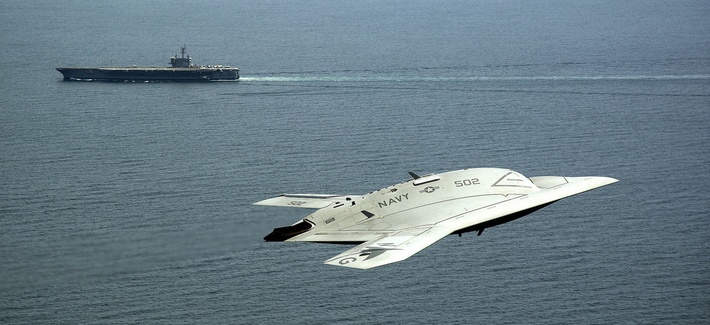 An X-47B drone, part of the Unmanned Combat Air System program, flies past the USS George H.W. Bush during a demonstration on May 14, 2013. An X-47B drone, part of the Unmanned Combat Air System program, flies past the USS George H.W. Bush during a demonstration on May 14, 2013.