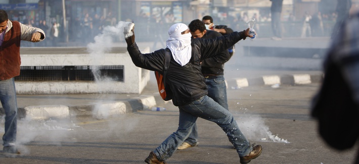 A protestor throws a canister of tear gas during a demonstration in Cairo, Egypt on January 25, 2011 A protestor throws a canister of tear gas during a demonstration in Cairo, Egypt on January 25, 2011