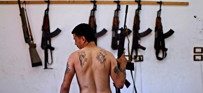 A Syrian rebel fighter poses after returning from fighting against Syrian army forces in Aleppo, Aug. 26, 2012.