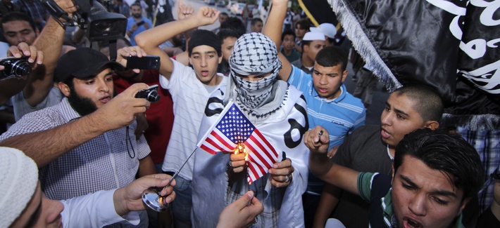 Supporters of the al-Qaeda-linked militant group Ansar al-Shariah burn an American flag in Benghazi, Libya in October. Supporters of the al-Qaeda-linked militant group Ansar al-Shariah burn an American flag in Benghazi, Libya in October.