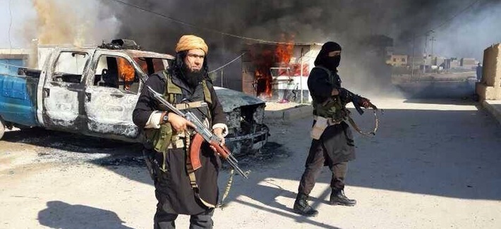 Shakir Waheib, a senior member of the al-Qaeda linked Islamic State of Iraq and the Levant, stands next to a burning police vehicle in Iraq's Anbar Province on January 4, 2014. Shakir Waheib, a senior member of the al-Qaeda linked Islamic State of Iraq and the Levant, stands next to a burning police vehicle in Iraq's Anbar Province on January 4, 2014.
