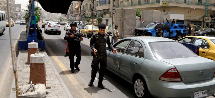 Iraqi federal policemen stand guard at a checkpoint in Baghdad on Wednesday. Iraqi federal policemen stand guard at a checkpoint in Baghdad on Wednesday.