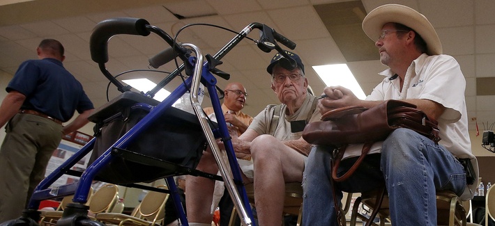 A World War 2 veteran and his son wait to speak to someone at a health care crisis center set up by the American Legion, on June 10, 2014. A World War 2 veteran and his son wait to speak to someone at a health care crisis center set up by the American Legion, on June 10, 2014.