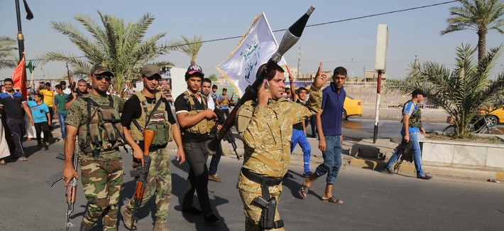 Shiite tribal fighters raise their weapons and chant slogans against the ISIS in Baghdad's Shula neighborhood, on June 16, 2014. Shiite tribal fighters raise their weapons and chant slogans against the ISIS in Baghdad's Shula neighborhood, on June 16, 2014.