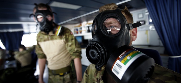 A member of the Danish military dons a protective mask while carrying out emergency drills aboard a frigate, on January 3, 2014. A member of the Danish military dons a protective mask while carrying out emergency drills aboard a frigate, on January 3, 2014.