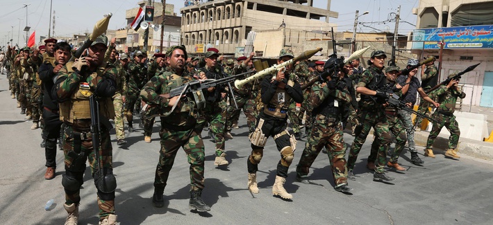 Volunteers of the newly formed "Peace Brigade" march in a demonstration in Sadr City, Baghdad, Iraq, on June 21, 2014. Volunteers of the newly formed "Peace Brigade" march in a demonstration in Sadr City, Baghdad, Iraq, on June 21, 2014.