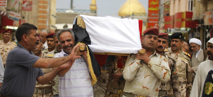 Mourners carry the flag draped coffin of an Iraqi Army colonel who was killed by Al Qaeda fighters, on April 14, 2014. Mourners carry the flag draped coffin of an Iraqi Army colonel who was killed by Al Qaeda fighters, on April 14, 2014.