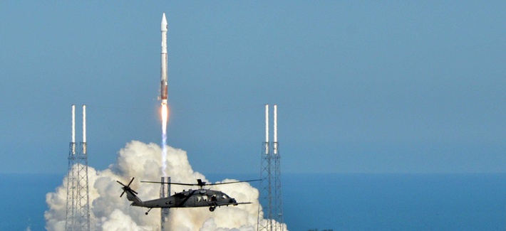 An Air Force helicopter flies by as an Atlas V rocket carrying a Space Based Infrared System GEO-2 rocket launches from Cape Canaveral, on March 21, 2013 An Air Force helicopter flies by as an Atlas V rocket carrying a Space Based Infrared System GEO-2 rocket launches from Cape Canaveral, on March 21, 2013