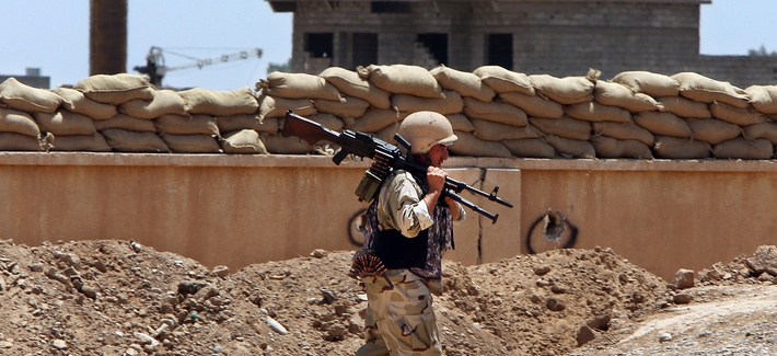 A Kurdish peshmerga fighter carries his weapon to a base near the oil-rich province of Kirkuk in Northern Iraq, on June 25, 2014. A Kurdish peshmerga fighter carries his weapon to a base near the oil-rich province of Kirkuk in Northern Iraq, on June 25, 2014.