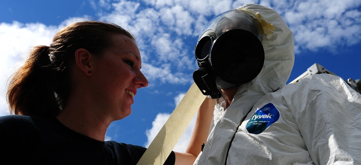 An emergency manager from the 628th Civil Engineer Squadron tapes down the mask of an Airman during a simulated dirty bomb attack, Aug. 24, 2012, at Joint Base Charleston, S.C. An emergency manager from the 628th Civil Engineer Squadron tapes down the mask of an Airman during a simulated dirty bomb attack, Aug. 24, 2012, at Joint Base Charleston, S.C.