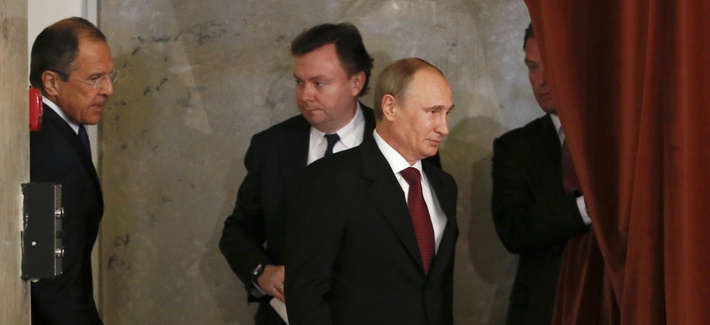 Russian President Vladimir Putin listens to the national anthem before a meeting with diplomats at the Foreign Ministry headquarters on Tuesday. Russian President Vladimir Putin listens to the national anthem before a meeting with diplomats at the Foreign Ministry headquarters on Tuesday.