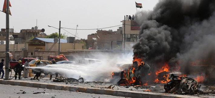 Iraqi firefighters try to extinguish burning vehicles moments after one in a series of bombs hit the Shiite stronghold of Sadr City, in Baghdad, Iraq, May 13, 2014. Iraqi firefighters try to extinguish burning vehicles moments after one in a series of bombs hit the Shiite stronghold of Sadr City, in Baghdad, Iraq, May 13, 2014.