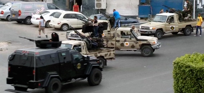 Tripoli joint security forces guard the entrance road to the parliament area after troops of Gen. Khalifa Hifter targeted Islamist lawmakers and officials at the parliament in Tripoli, Libya, in mid May. Tripoli joint security forces guard the entrance road to the parliament area after troops of Gen. Khalifa Hifter targeted Islamist lawmakers and officials at the parliament in Tripoli, Libya, in mid May.