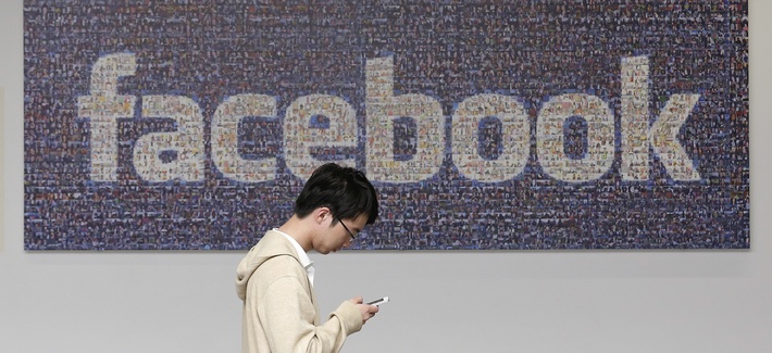A man walks past a Facebook sign at the company's campus in Menlo Park, Calif., on June 11, 2014. A man walks past a Facebook sign at the company's campus in Menlo Park, Calif., on June 11, 2014.