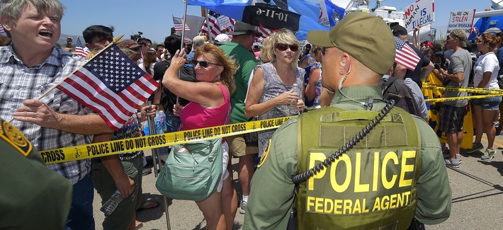 Immigration demonstrators in Murietta, Calif., yell to a Customs and Border Protection officer, on July 4, 2014. Immigration demonstrators in Murietta, Calif., yell to a Customs and Border Protection officer, on July 4, 2014.