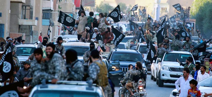 ISIL militants in Raqqa, Syria, wave flags during a military parade, on June 30, 2014. ISIL militants in Raqqa, Syria, wave flags during a military parade, on June 30, 2014.