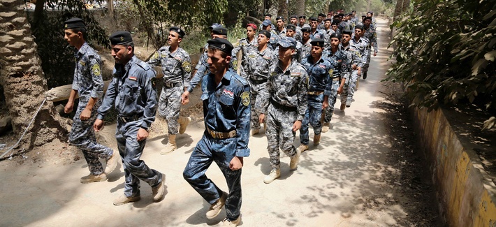 Iraqi police officers and new recruits march at a recruiting office in Baghdad, Iraq, on July 5, 2014. Iraqi police officers and new recruits march at a recruiting office in Baghdad, Iraq, on July 5, 2014.