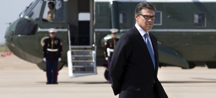 Texas Gov. Rick Perry waits to meet President Obama on the tarmac in Dallas prior to a meeting, on July 9, 2014. Texas Gov. Rick Perry waits to meet President Obama on the tarmac in Dallas prior to a meeting, on July 9, 2014.