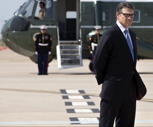 Texas Gov. Rick Perry waits to meet President Obama on the tarmac in Dallas prior to a meeting, on July 9, 2014. Texas Gov. Rick Perry waits to meet President Obama on the tarmac in Dallas prior to a meeting, on July 9, 2014.