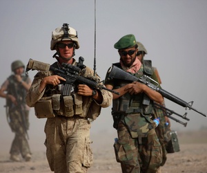 A U.S. Marine with Bravo Company, 1st Battalion 5th Marines walks with Afghan National Army officer during in a joint patrol in Nawa district, Helmand province, southern Afghanistan, Oct. 3, 2009. A U.S. Marine with Bravo Company, 1st Battalion 5th Marines walks with Afghan National Army officer during in a joint patrol in Nawa district, Helmand province, southern Afghanistan, Oct. 3, 2009.