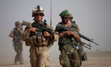 A U.S. Marine with Bravo Company, 1st Battalion 5th Marines walks with Afghan National Army officer during in a joint patrol in Nawa district, Helmand province, southern Afghanistan, Oct. 3, 2009. A U.S. Marine with Bravo Company, 1st Battalion 5th Marines walks with Afghan National Army officer during in a joint patrol in Nawa district, Helmand province, southern Afghanistan, Oct. 3, 2009.