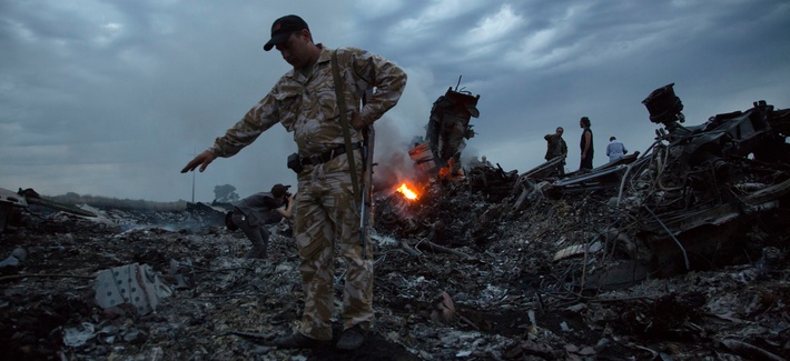 People walk amongst the debris at the crash site of a passenger plane near the village of Hrabove, Ukraine, July 17, 2014. People walk amongst the debris at the crash site of a passenger plane near the village of Hrabove, Ukraine, July 17, 2014.