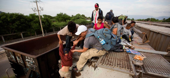 Central American migrants board a northbound freight train in Ixtepec, Mexico. Central American migrants board a northbound freight train in Ixtepec, Mexico.