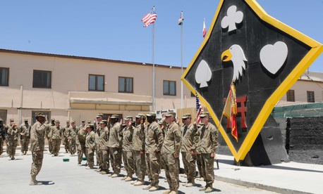 An Army colonel administers a reenlistment oath to soldiers assigned to Task Force Lifeliner at Bagram Airfield. 
