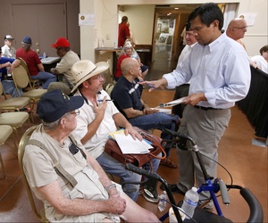 A VA official helps out two vets at a crisis center set up by the American Legion in Phoenix, on June 10, 2014. 