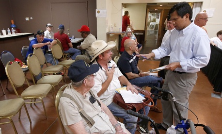 A VA official helps out two vets at a crisis center set up by the American Legion in Phoenix, on June 10, 2014. 