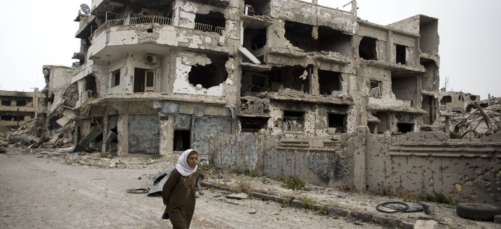 A woman walks through a devastated part of Homs, Syria, on June 5, 2014. A woman walks through a devastated part of Homs, Syria, on June 5, 2014.