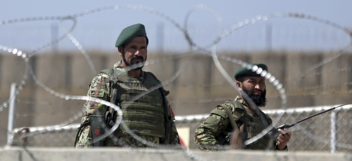 Afghan National Army soldiers stand guard at the gate of Camp Qargha, where a man opened fire on coalition and Afghan troops on Tuesday. Afghan National Army soldiers stand guard at the gate of Camp Qargha, where a man opened fire on coalition and Afghan troops on Tuesday.