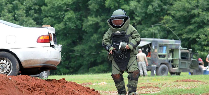 A member of the 202nd Explosive Ordnance Disposal Company runs a detonation cored from the trunk of a vehicle during a training exercise with federal and state law enforcement agencies. A member of the 202nd Explosive Ordnance Disposal Company runs a detonation cored from the trunk of a vehicle during a training exercise with federal and state law enforcement agencies.