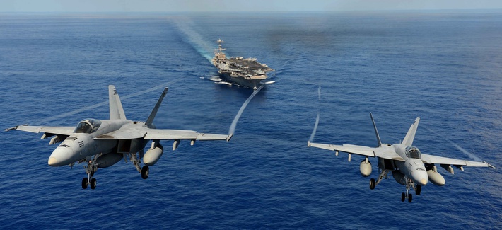 Two F/A 18s with the Strike Fighter Squadron 14 participate in a demonstration over the USS John C. Stennis. Two F/A 18s with the Strike Fighter Squadron 14 participate in a demonstration over the USS John C. Stennis.