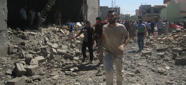Iraqis inspect the site of a double car bomb attack in Kirkuk, Iraq on August 7, 2014. Iraqis inspect the site of a double car bomb attack in Kirkuk, Iraq on August 7, 2014.