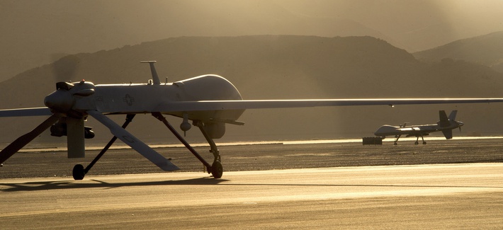 An MQ-1B Predator and an MQ-9 Reaper taxi to the end of a runway at Creech Air Force Base in preparation for takeoff, on June 13, 2014. An MQ-1B Predator and an MQ-9 Reaper taxi to the end of a runway at Creech Air Force Base in preparation for takeoff, on June 13, 2014.