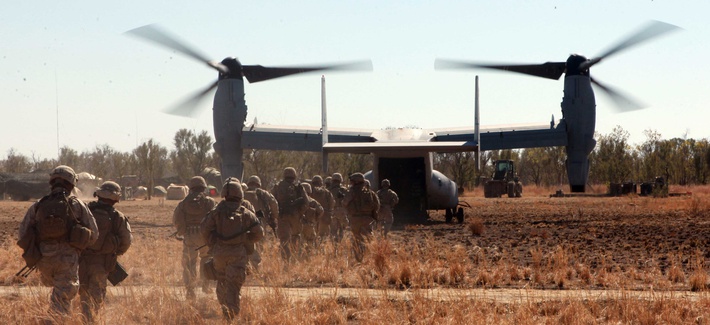 Marines with the Marine Rotational Force-Darwin load into an MV-22B Osprey during Exercise Koolendong at Bradshaw Training Field Area, Northern Territories, Australia. Marines with the Marine Rotational Force-Darwin load into an MV-22B Osprey during Exercise Koolendong at Bradshaw Training Field Area, Northern Territories, Australia.