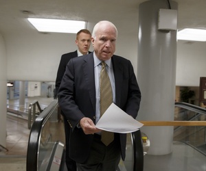 Sen. John McCain, R-Ariz., heads to the chamber to advance a bill in the Senate, on March 24, 2014. 