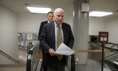 Sen. John McCain, R-Ariz., heads to the chamber to advance a bill in the Senate, on March 24, 2014. 